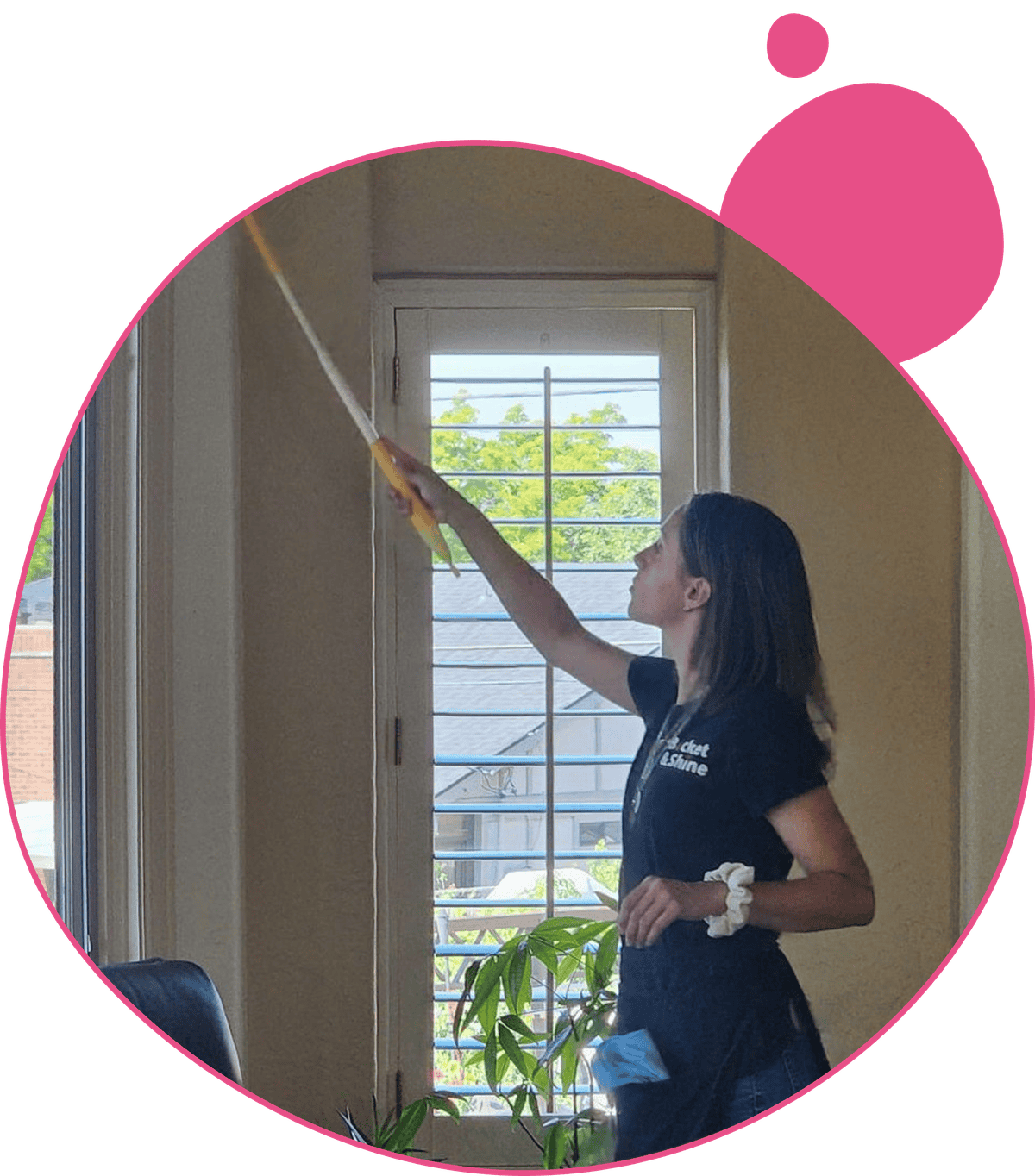 Bucket & Shine cleaner dusting high window trim during a house cleaning in Denver, CO
